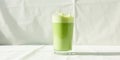 Refreshing iced matcha latte in a tall glass on white fabric. Generative AI Royalty Free Stock Photo