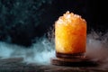 Refreshing Iced Orange Cocktail with Smoke Effect on Dark Background. Royalty Free Stock Photo