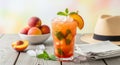 Refreshing Iced Peach Drink with Mint and Fresh Peaches on a Rustic Table Royalty Free Stock Photo
