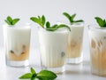 Refreshing iced tea drinks layered with milk and garnished with mint. Royalty Free Stock Photo