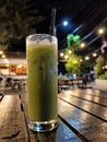 Refreshing and Inviting: A Cold Green Tea with a Cafe Ambience