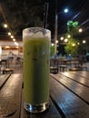 Refreshing and Inviting: A Cold Green Tea with a Cafe Ambience