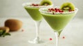 Refreshing kiwi smoothie in elegant glasses with pomegranate garnish Royalty Free Stock Photo