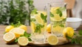 Refreshing lemon and lime infused water in traditional glasses on a white kitchen counter