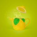 Refreshing Lemon Tea. Tea concept with lemon teapot, tea leaves and steam. Tea time concept Royalty Free Stock Photo