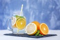 Refreshing lemonade with lemon, orange and mint. Glass jar and t