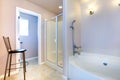 Refreshing light lavender bathroom with white bath tub and shower