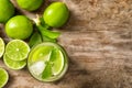 Refreshing lime beverage and ingredients on wooden background Royalty Free Stock Photo