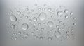 Refreshing macro view of numerous clear water drops glistening on a smooth, cool gray surface, perfect for a clean abstract Royalty Free Stock Photo