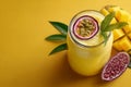 Refreshing Mango Passion Fruit Smoothie on Yellow Background Royalty Free Stock Photo