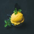 Refreshing Mango sorbet ice-cream scoop in scooper, square crop