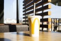 Refreshing McDonald Drink Milkshake In Big White Cup With Logo, Paper Straw on Table In