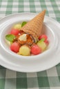 Refreshing melon ice cream with a cone in a white plate. Delicious summer dessert. Cold ice cream fruit sorbet