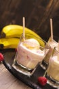 Refreshing milk cocktail with ice cream scoops, raspberry and banana Royalty Free Stock Photo