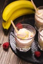 Refreshing milk cocktail with ice cream scoops, raspberry and banana Royalty Free Stock Photo