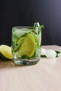 Refreshing mint cocktail mojito with rum and lime, cold drink or beverage with ice on black background Royalty Free Stock Photo