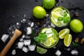Refreshing mint cocktail mojito with rum and lime, cold drink or beverage with ice on black background, Royalty Free Stock Photo