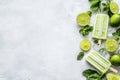 A vibrant assortment of mint and lime popsicles rests on a light gray surface alongside Royalty Free Stock Photo