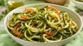 A refreshing mix of spiralized zucchini and carrot noodles generously coated in a rich, herby pesto sauce, nestled in a