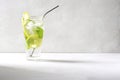 A refreshing mojito cocktail in a tall glass goblet with lime wedges, ice and mint stands on a gray concrete background. Royalty Free Stock Photo