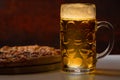 Refreshing mug of chilled beer with pizza Royalty Free Stock Photo