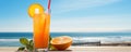 Refreshing orange cocktail on beach table