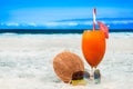 Refreshing orange cocktail on beach table. Vacation at Paradise