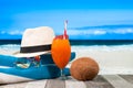 Refreshing orange cocktail on beach table. Vacation at Paradise