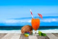 Refreshing orange cocktail on beach table. Vacation at Paradise