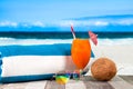 Refreshing orange cocktail on beach table. Vacation at Paradise