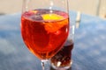 Refreshing orange summer cocktails with cola and ice against a blue sky background. Close up view