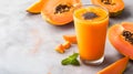 Refreshing papaya smoothie on light grey background with copy space. Glass of smooth papaya juice with seeds and fresh papaya Royalty Free Stock Photo
