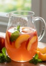 Refreshing Peach and Mint Summer Drink in Glass Pitcher Royalty Free Stock Photo