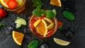 Refreshing Pimms Cocktail with Fruit and vegetables on rustic black table Royalty Free Stock Photo