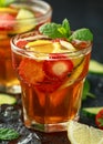 Refreshing Pimms Cocktail with Fruit and vegetables on rustic black table Royalty Free Stock Photo