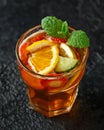 Refreshing Pimms Cocktail with Fruit and vegetables on rustic black table Royalty Free Stock Photo