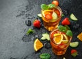 Refreshing Pimms Cocktail with Fruit and vegetables on rustic black table Royalty Free Stock Photo