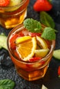 Refreshing Pimms Cocktail with Fruit and vegetables on rustic black table Royalty Free Stock Photo
