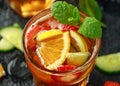 Refreshing Pimms Cocktail with Fruit and vegetables on rustic black table Royalty Free Stock Photo