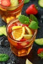 Refreshing Pimms Cocktail with Fruit and vegetables on rustic black table Royalty Free Stock Photo