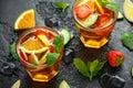 Refreshing Pimms Cocktail with Fruit and vegetables on rustic black table Royalty Free Stock Photo