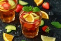 Refreshing Pimms Cocktail with Fruit and vegetables on rustic black table Royalty Free Stock Photo