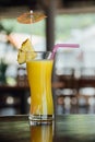 Refreshing pineapple cocktail glass with slices of pineapple, pink juice straws and decoration Royalty Free Stock Photo