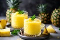 Refreshing pineapple juice in glass with fresh pineapples, summer drink