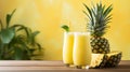 Refreshing pineapple juice in glass on wooden table, isolated on soft yellow background