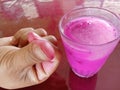 Refreshing pink iced juice in a glass