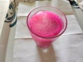 Refreshing pink iced juice in a glass