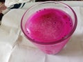 Refreshing pink iced juice in a glass