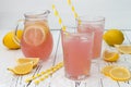 Refreshing pink lemonade on white old vintage wooden background.