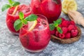 Refreshing raspberry, lemon and mint lemonade with sparkling water in a glass, horizontal